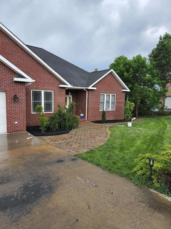Paver walkway at the front entry of a brick house