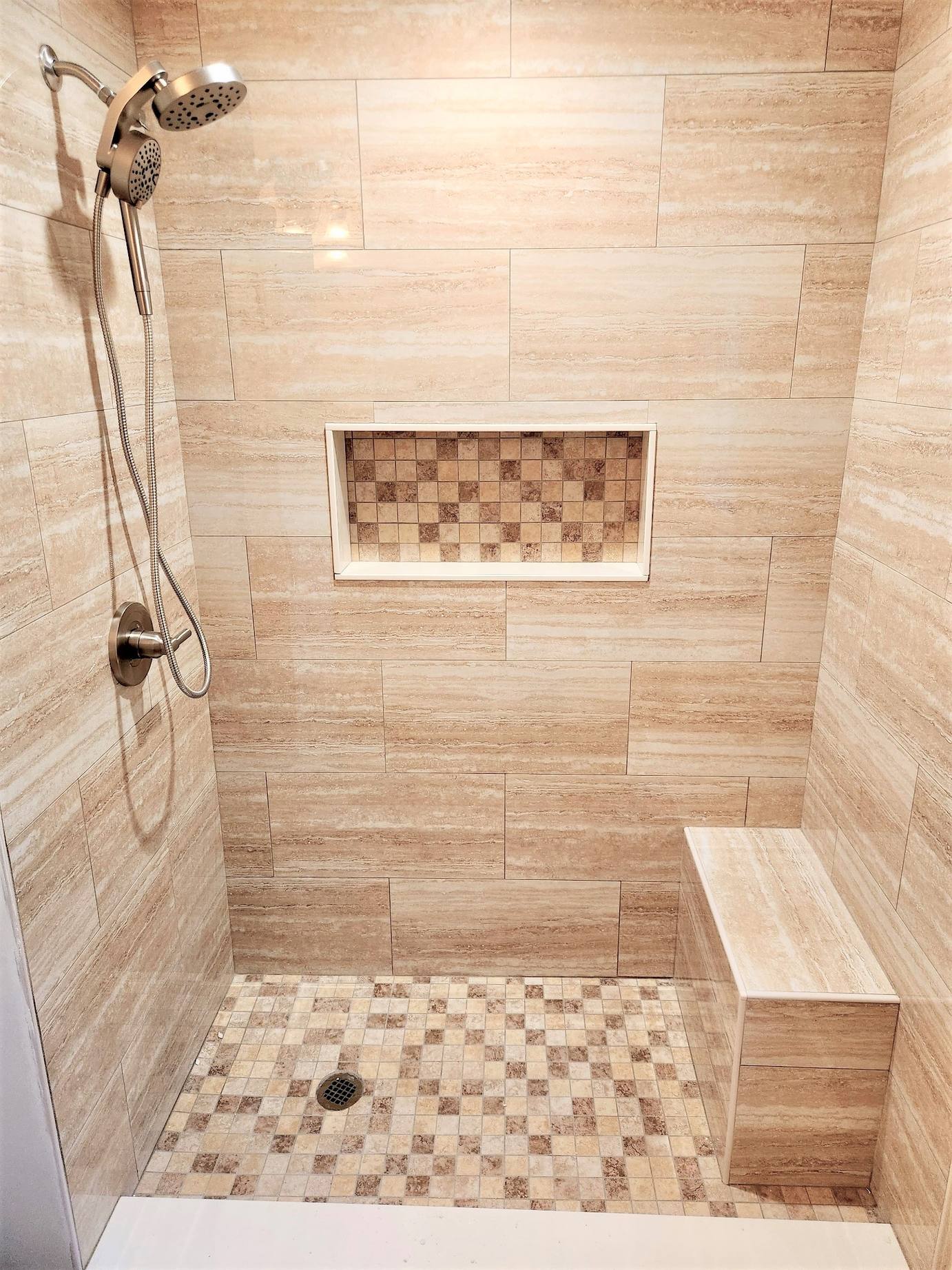 Tiled walk-in shower with a built-in bench